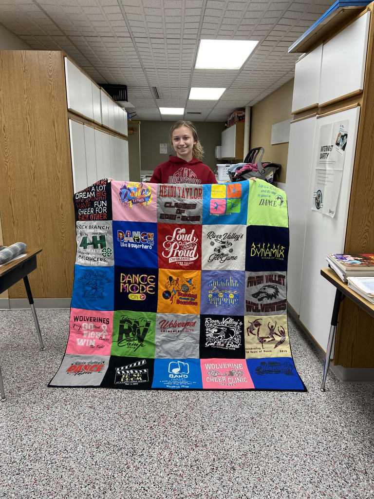 Heidi Taylor displaying her quilt.